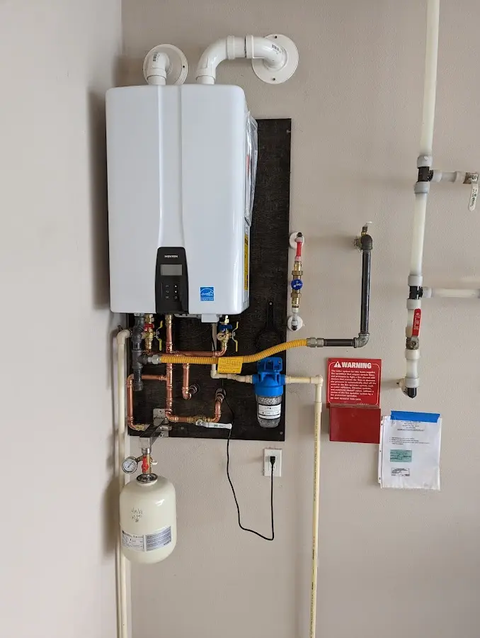 Professional plumber installing copper piping in a Estacada home